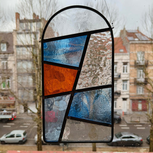 stained glass window hanger, sun catcher, in transparant, amber and blue glass.