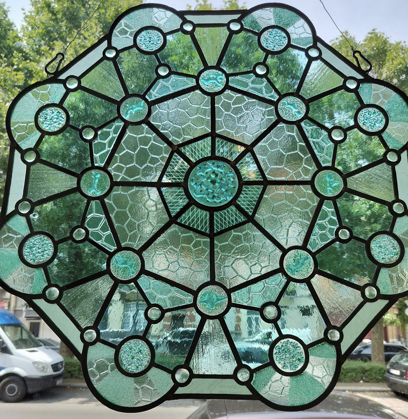 stained glass rose in turquoise colors, with molecular drawings and fused details.