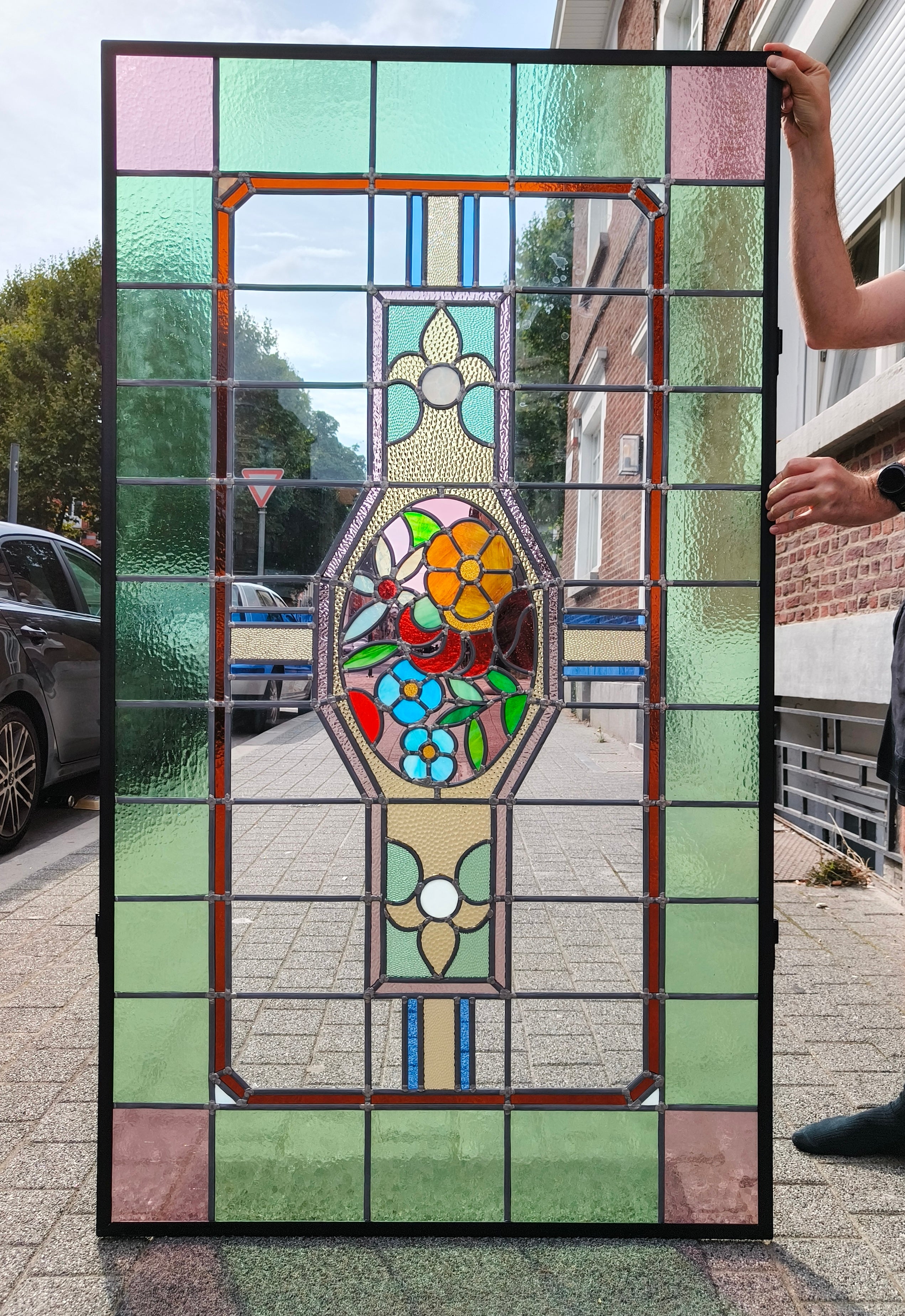 restored stained glass art deco floral window in metal frame.