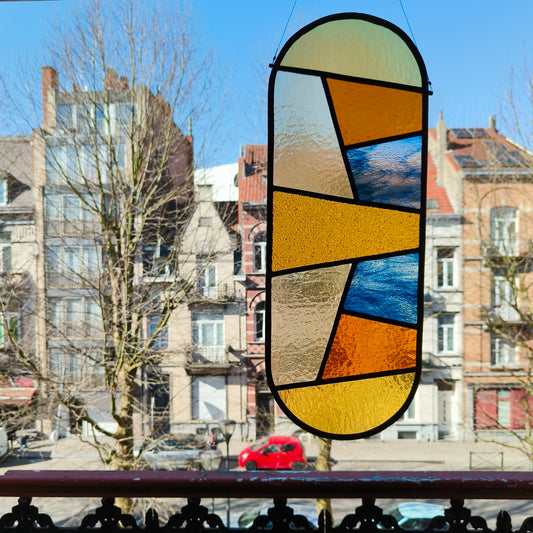 Stained glass window with warm yellow and blues.