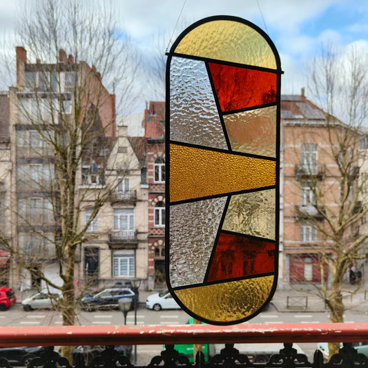 Stained glass window in transparant stuctures, yellows and some amber glass.