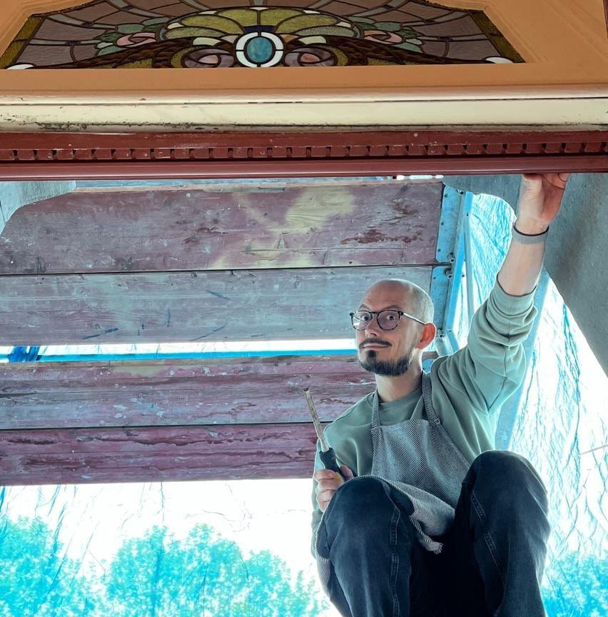 Arne on a scaffolding during a restoration of a stained glass window.